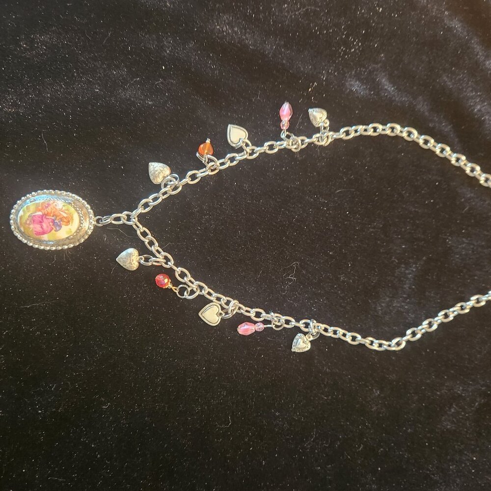 22" silver tone necklace with vintage pendant.